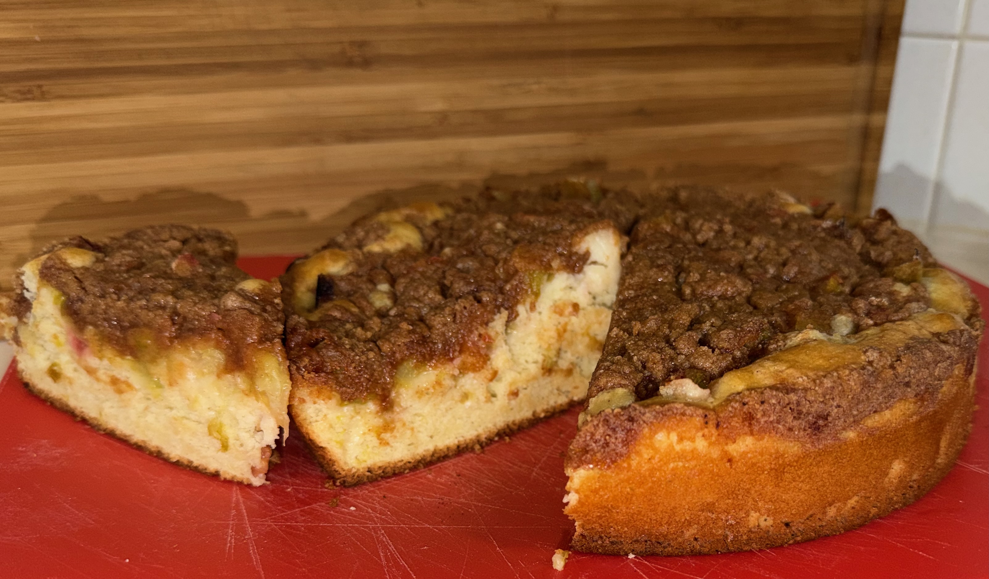 A rhubarb coffee cake with cinnamon streusel topping in a baking pan